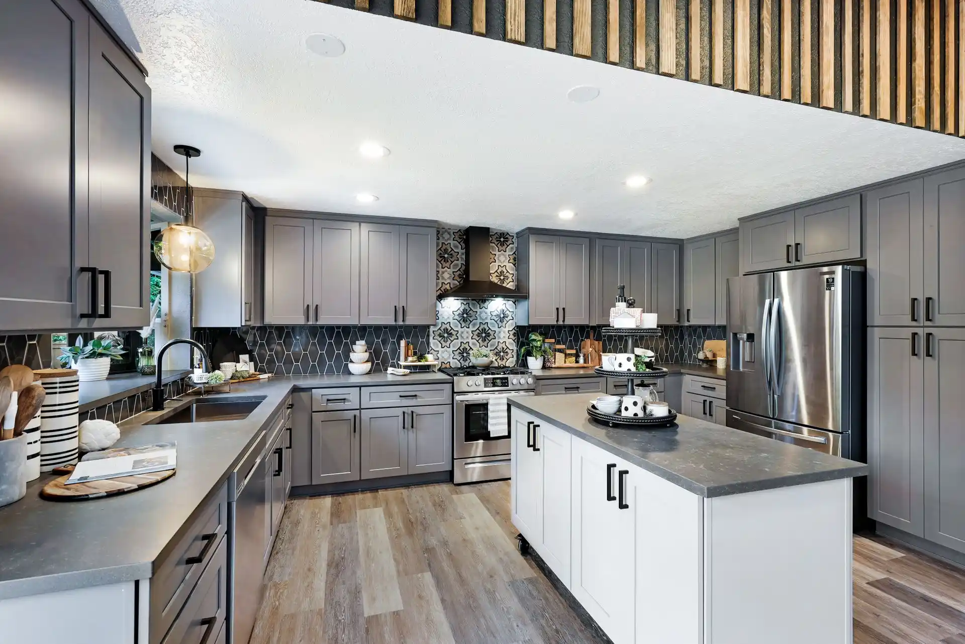 Two-tone grey and white shaker kitchen with matte black hardware