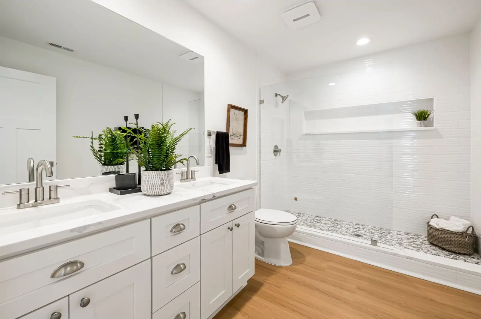 Bright white bathroom vanity with brushed nickel hardware