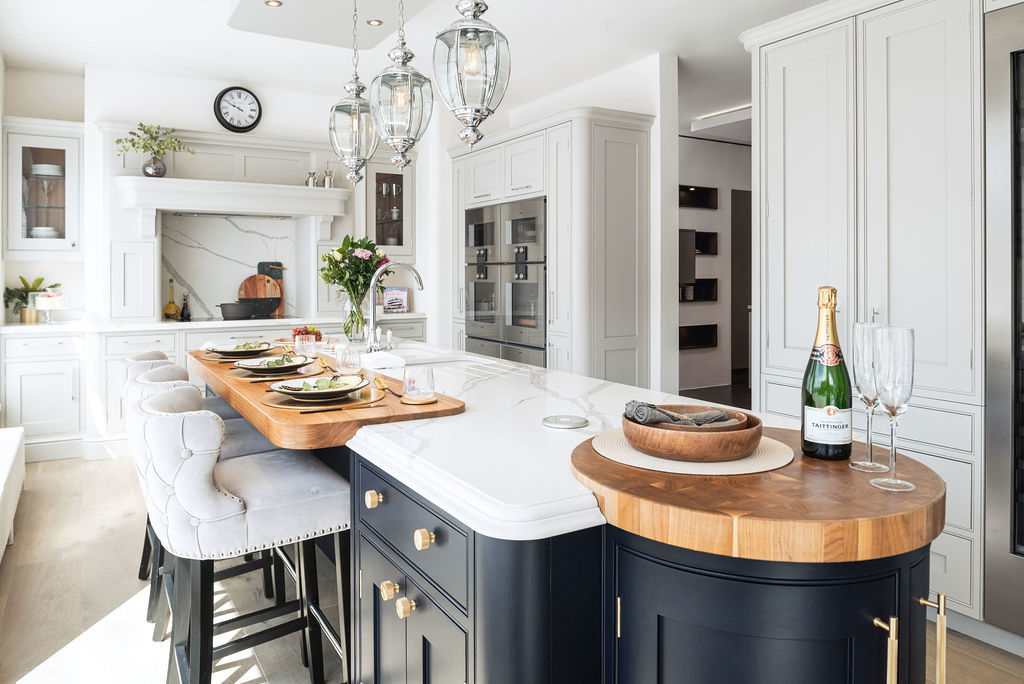 Luxury white and navy kitchen island with marble and butcher block