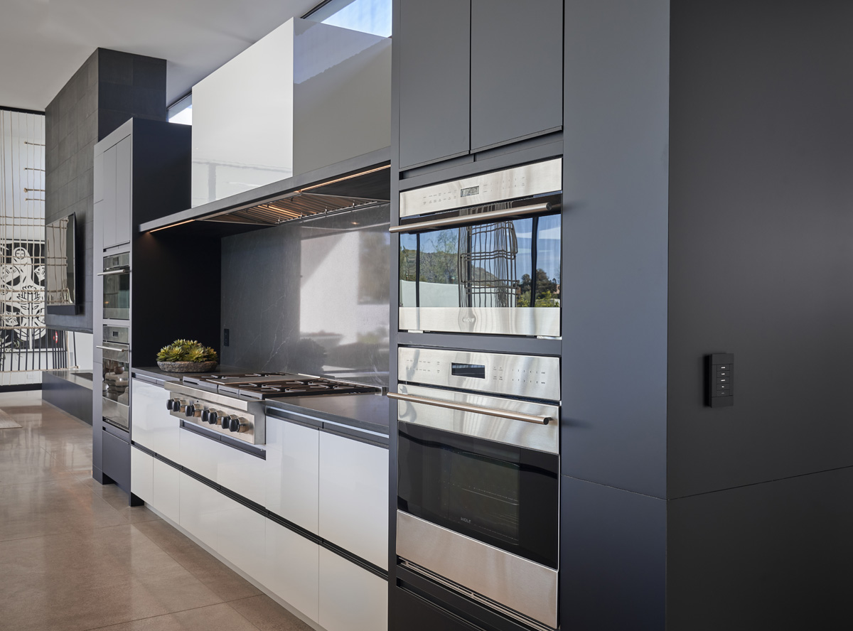 Modern high-gloss white and charcoal kitchen with premium appliances