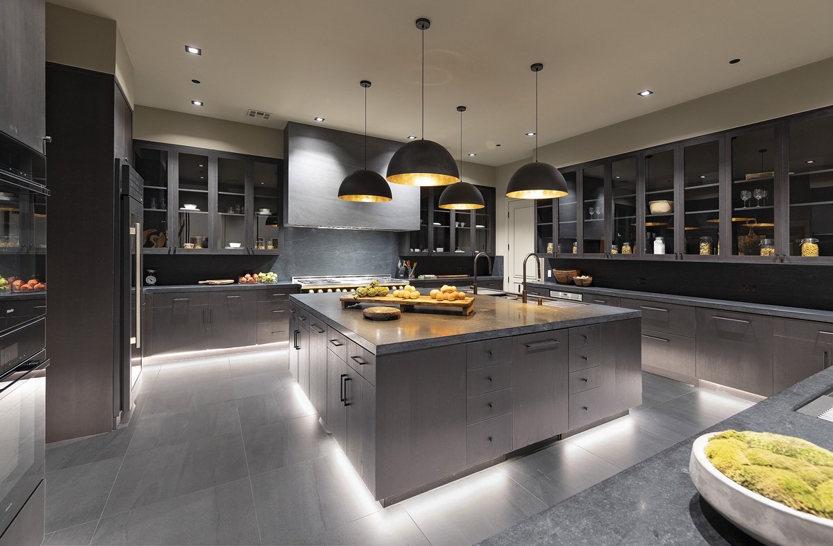 Contemporary dark cabinetry with LED accent lighting and pendant lamps